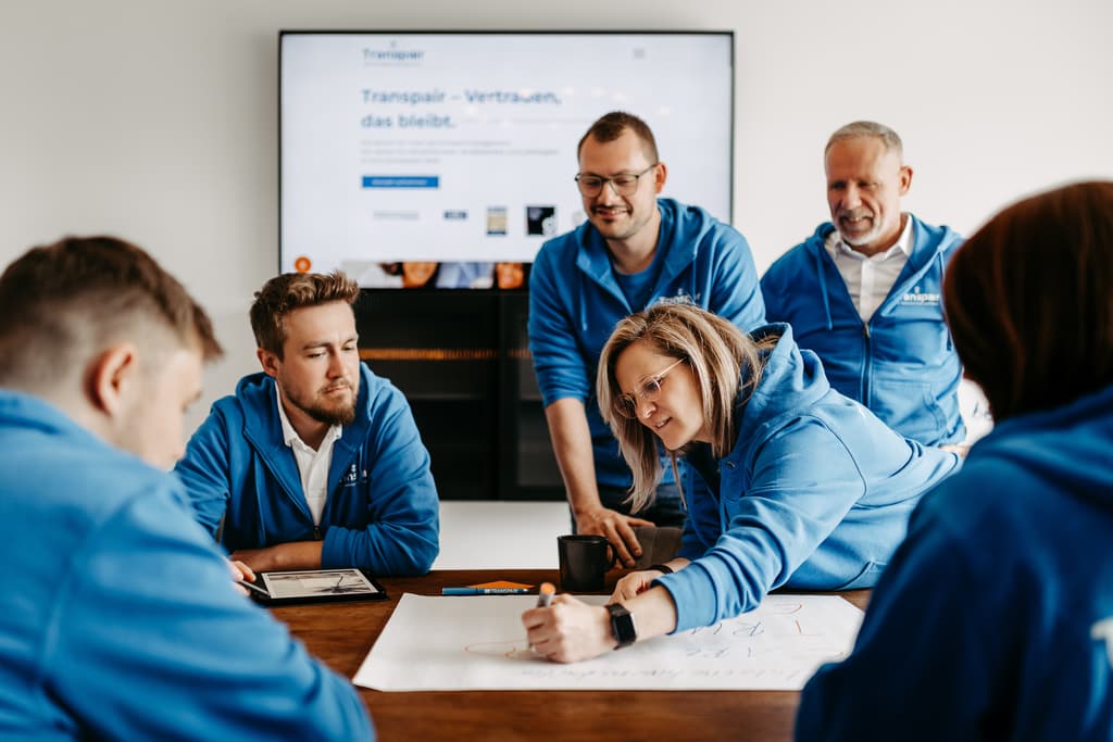 Transpair-Team im gemeinsamen Gespräch am Tisch